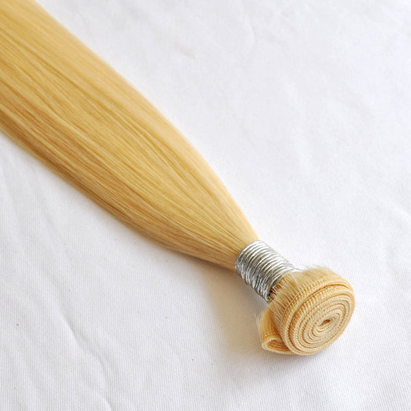 Blonde hair extensions on a white background