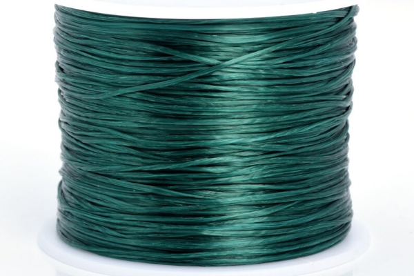 A spool of green crystal string elastic wig sewing thread.