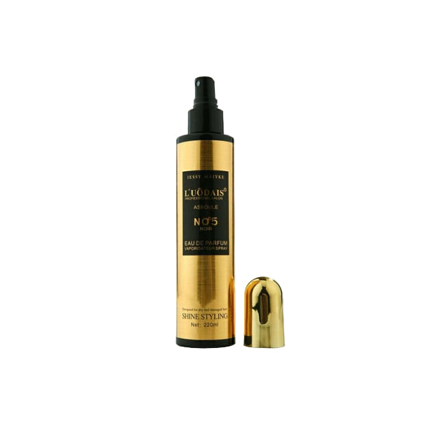 Gold and black perfume bottle with cap on a white background