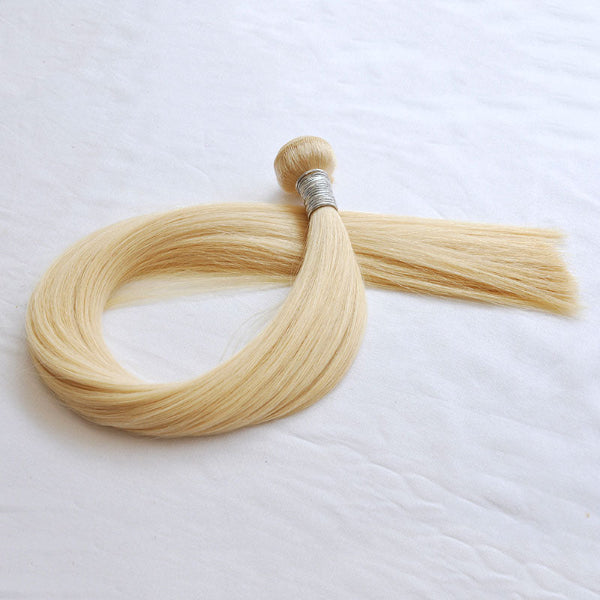 Blonde hair extensions on a white background